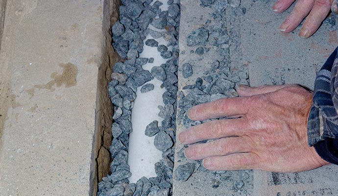 Professional installing interior footing drain