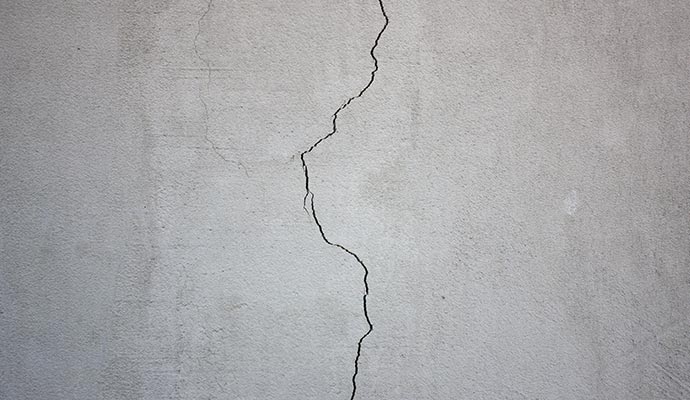 Close-up view of crack in crawl space drywall