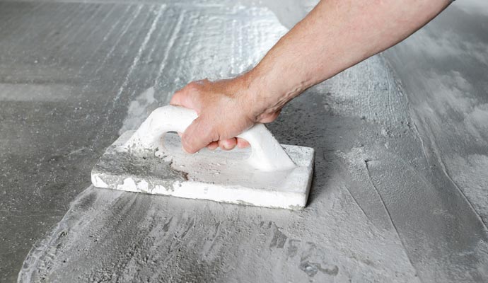 a person repairing a foundation floor