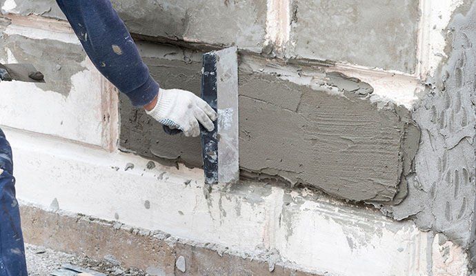 A professional repairing a foundation wall