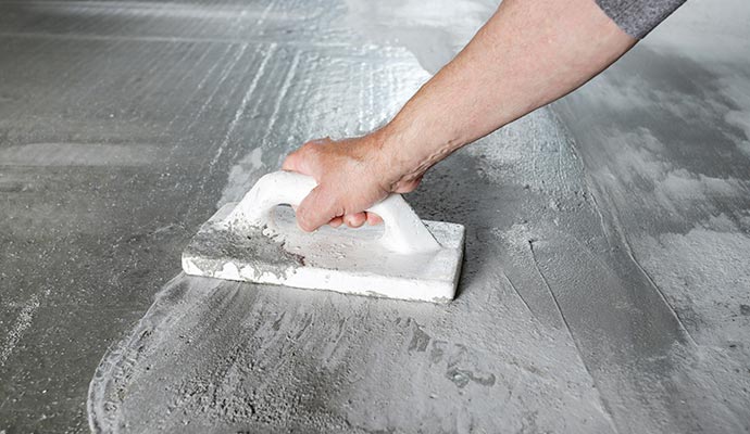 Expert repairing foundation floor using equipment.