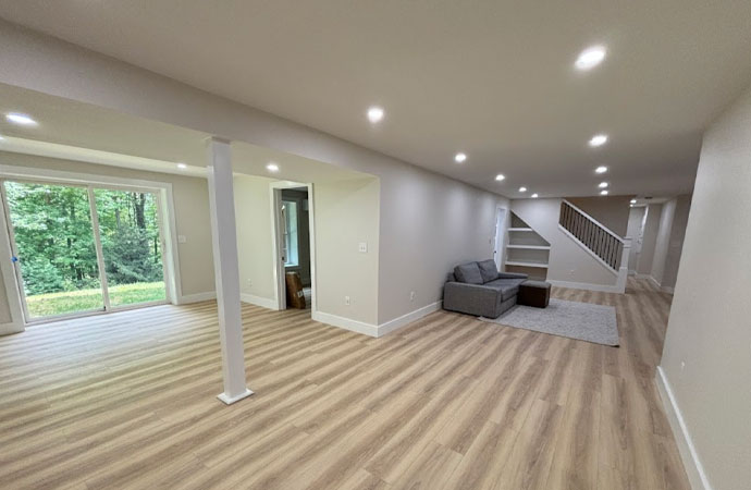 Transform your waterproofed basement with custom finishing services, flooring, and lighting in Hopkinton, MA.