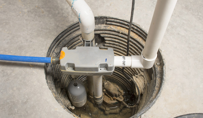 A sump pump installed in a concrete pit.