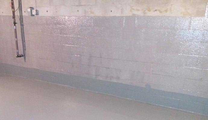 Waterproofed barrier wall